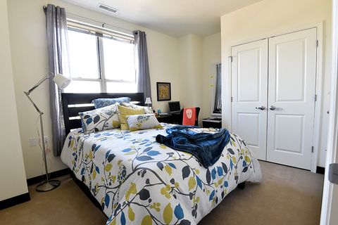 furnished bedroom with floral bed spread