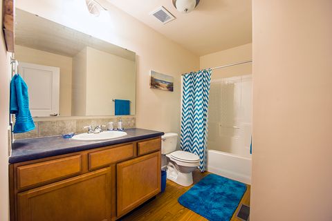 bathroom with blue towels and rugs